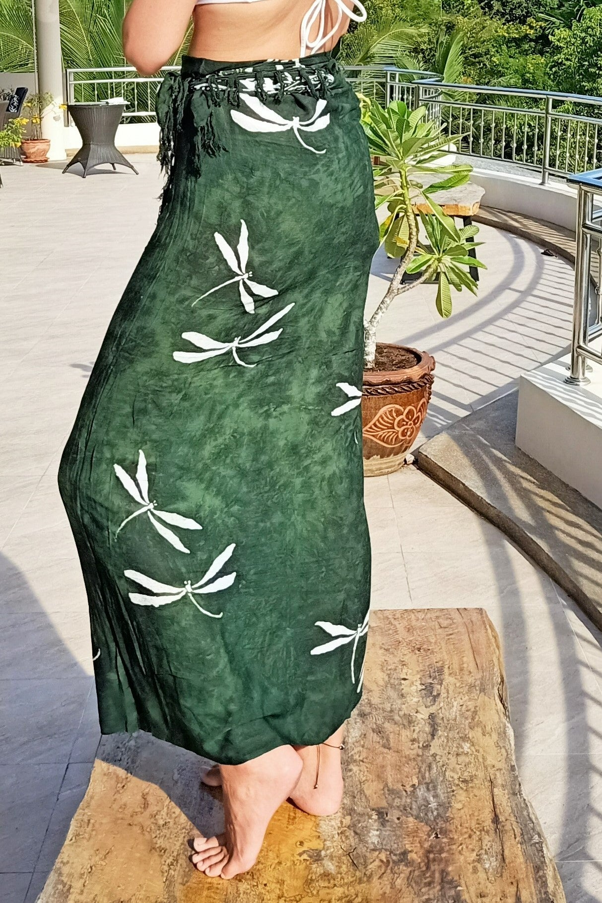 Green wrap around skirt sarong with white dragonfly pattern created with batik process. 