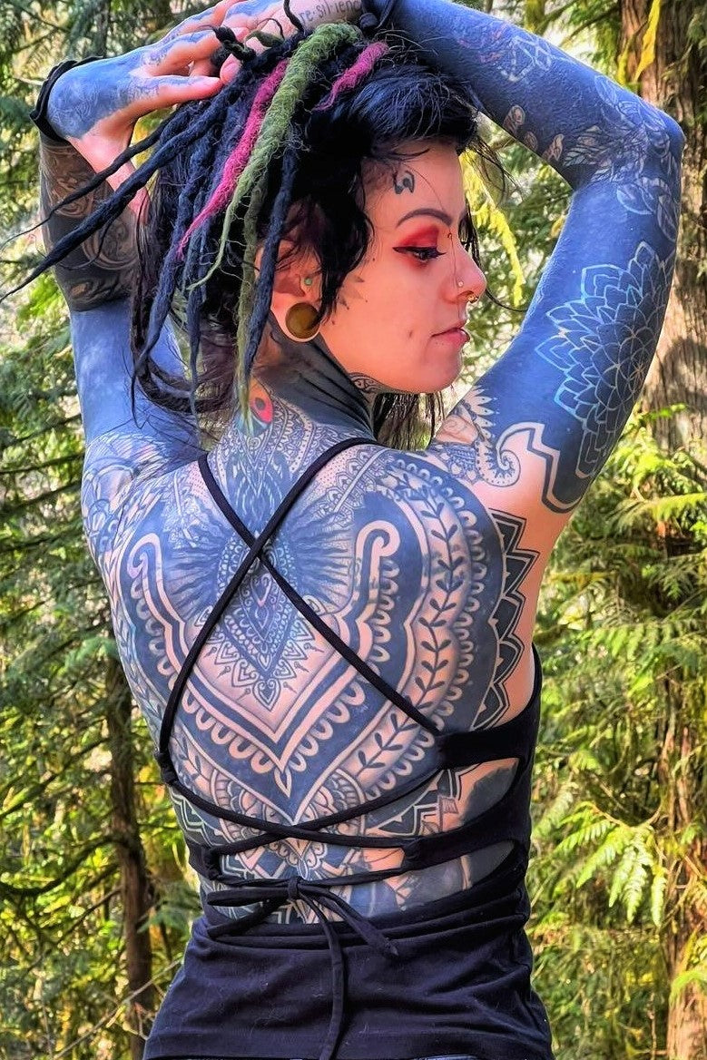 Onyx Lace Up Tank back view showing starps in doubel X pattern and tie back over tattooed woman's back. 