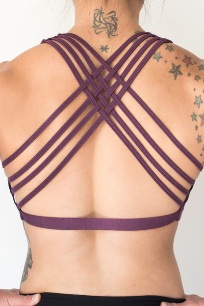 Plum colored sports bra that has 4 criss cross straps in back and has enough support for down dog and other yoga poses. 90% cotton 10% spandex 