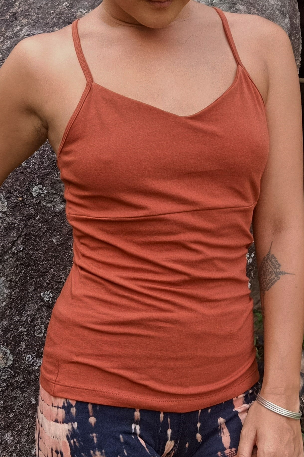 Front view of Ananda Tank in Rust color. Spaghetti straps and long length on torso. Full coverage with built in bra. 