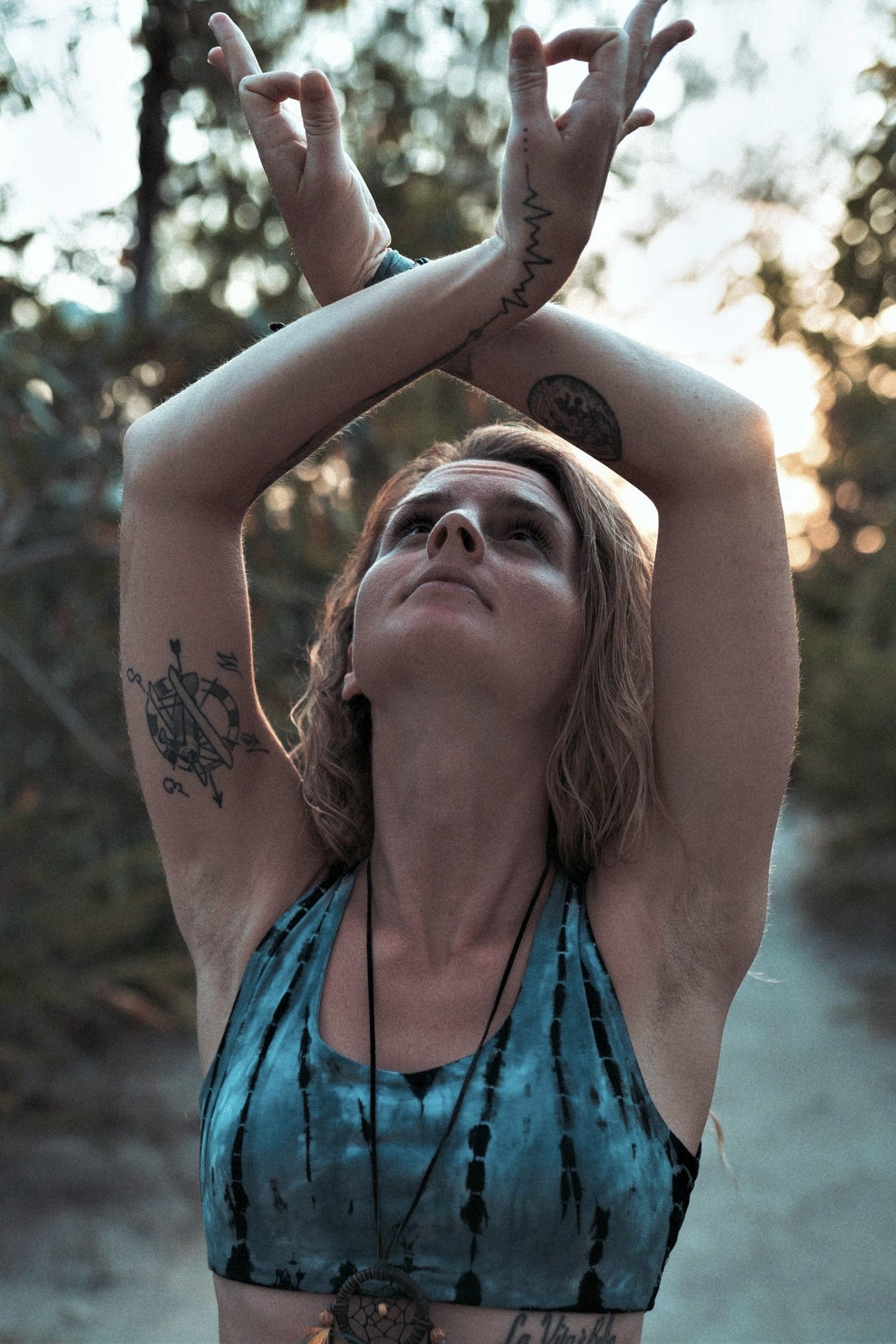 Beautiful steel blue tie dyed sportsbra with black streaks and white highlights worn by yogini. 