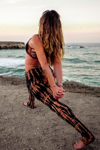 Fire tie dye, black with burnt orange highlights long length yoga pants with fold over top for adjustable fit can be worn with higher waist or lower on the hips. Soft, comfortable 90% cotton 10% spandex shown with matching Fitness Tank Top.